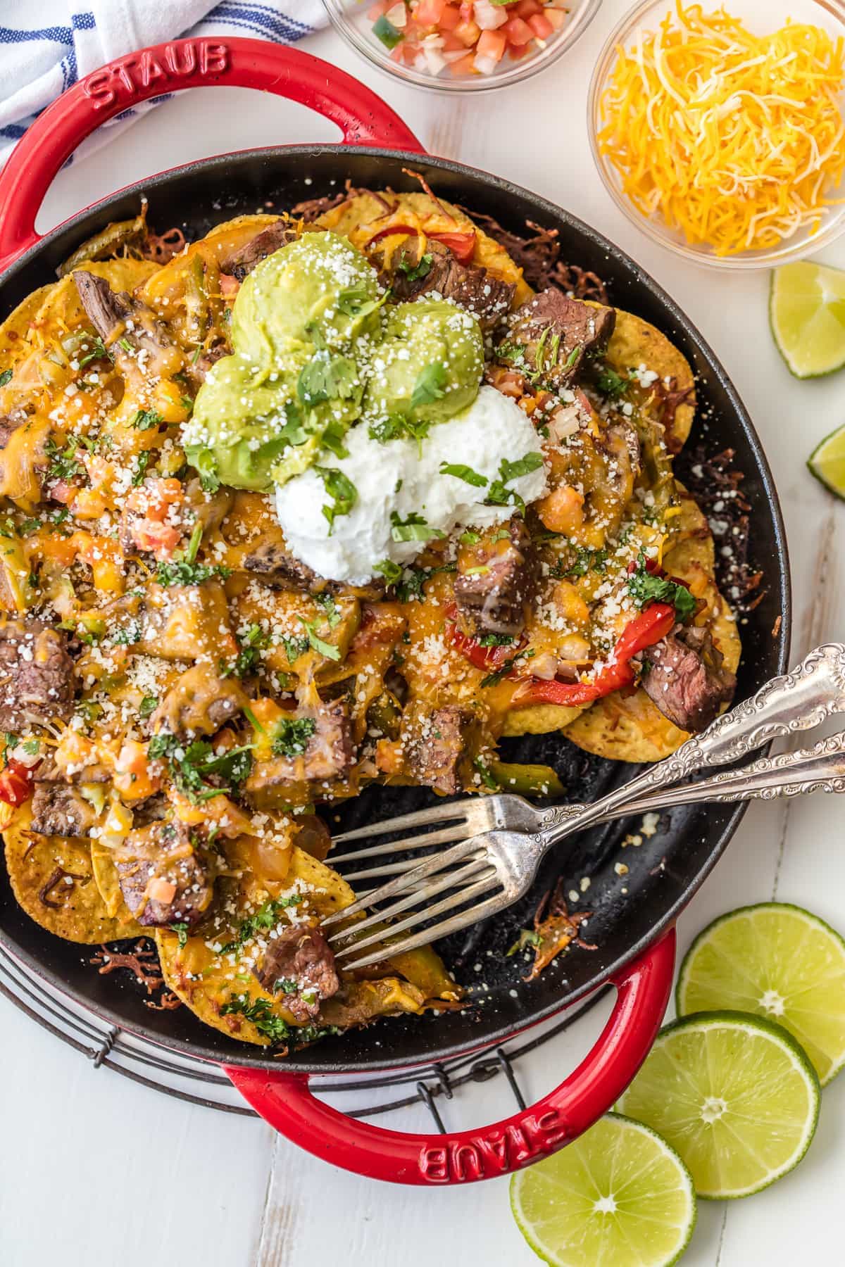 SKILLET STEAK FAJITA NACHOS are a must make for tailgating, the Super Bowl, or anytime! Loaded with marinated steak, peppers, onion, and cheese! BEST NACHOS EVER!