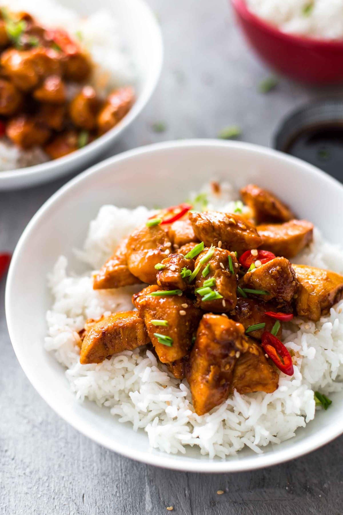 a bowl of white rice and bourbon chicken