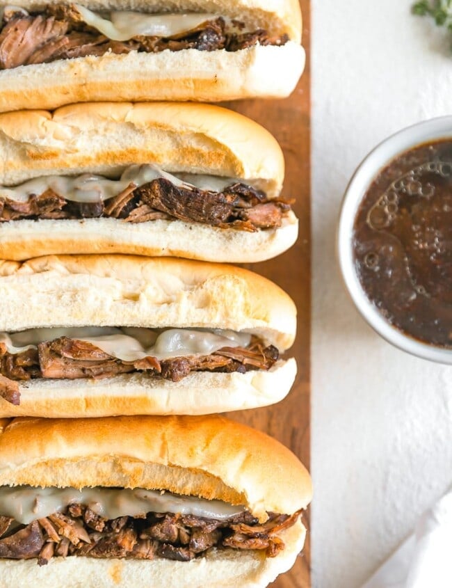 French Dip Sandwich, or French Dip Au Jus, is a delicious and easy way to enjoy crockpot beef! We create a Beef Au Jus sandwich with tender beef, provolone cheese, toasty bread, and of course the dipping sauce. Such a simple crockpot recipe that the entire family will love. This French Dip Sandwich Recipe is a winner!