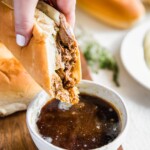 French Dip Sandwich, or French Dip Au Jus, is a delicious and easy way to enjoy crockpot beef! We create a Beef Au Jus sandwich with tender beef, provolone cheese, toasty bread, and of course the dipping sauce. Such a simple crockpot recipe that the entire family will love. This French Dip Sandwich Recipe is a winner!