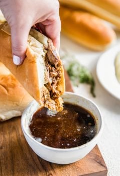 French Dip Sandwich, or French Dip Au Jus, is a delicious and easy way to enjoy crockpot beef! We create a Beef Au Jus sandwich with tender beef, provolone cheese, toasty bread, and of course the dipping sauce. Such a simple crockpot recipe that the entire family will love. This French Dip Sandwich Recipe is a winner!