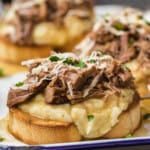 open faced roast beef sandwiches on a plate