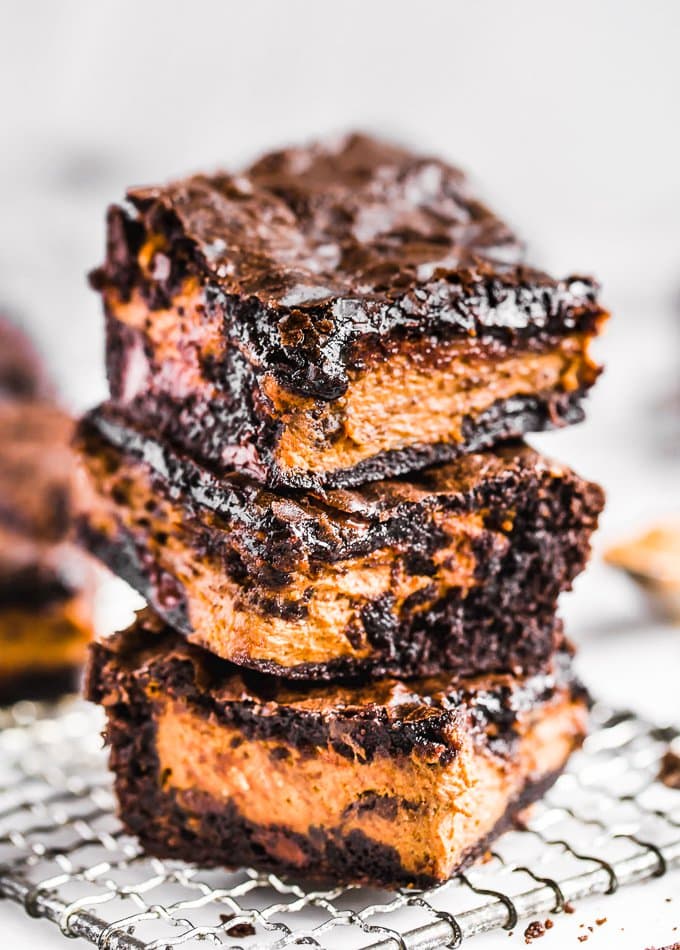 a stack of pumpkin brownies on a cooling rack.