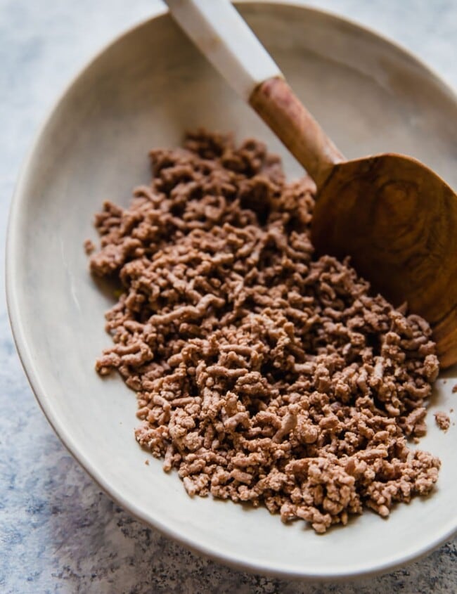Wondering how to cook ground beef? Frying is a popular option, but boiling ground beef is easy, quick, and it creates leaner meat! Cooking ground beef with this method creates the perfect crumbled ground beef for tacos, chili, spaghetti sauce, and more.