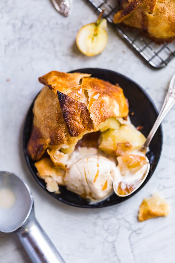 Apple dumpling on a plate with a scoop of ice cream