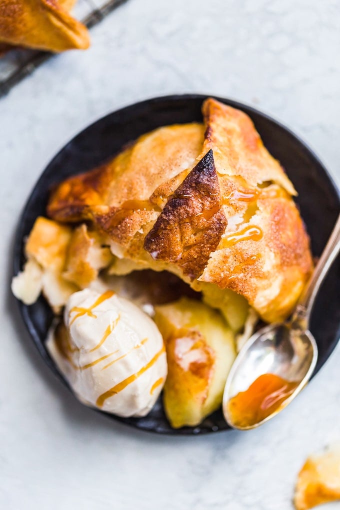 Apple dumpling on a plate with a scoop of ice cream