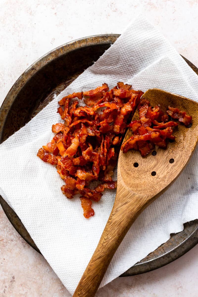 bacon crumbles with wooden spoon