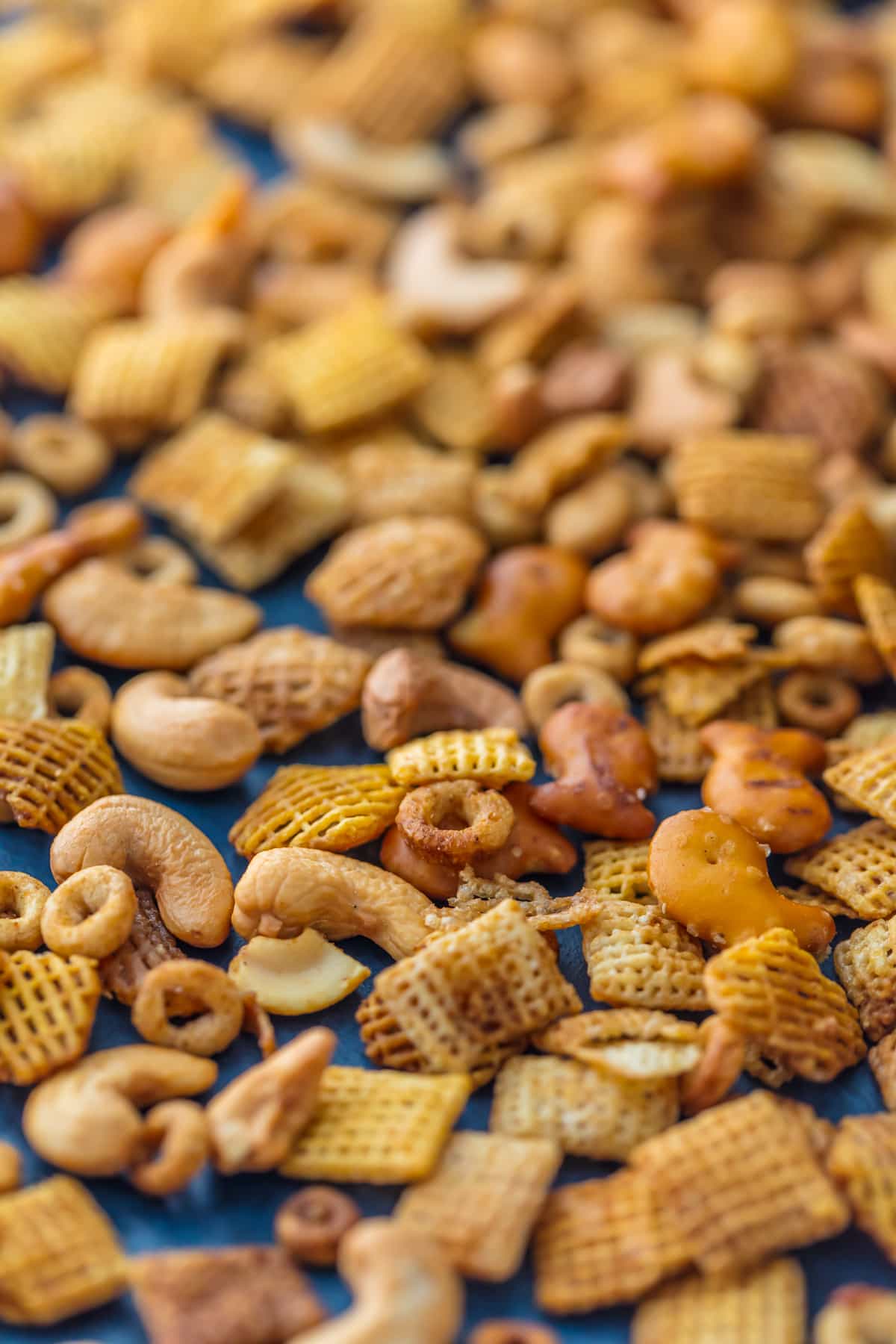 Chex Party Mix is a recipe my Mom has been making since I was a little kid. It's our family's favorite Chex Mix Recipe! It doesn't get better than this mix of cereal, nuts, pretzels, and all that spice! A little bit sweet and little bit spicy. This BEST EVER Chex Party Mix Recipe is perfect for Christmas, tailgating, Summer BBQs, and every day in between. SO ADDICTING!