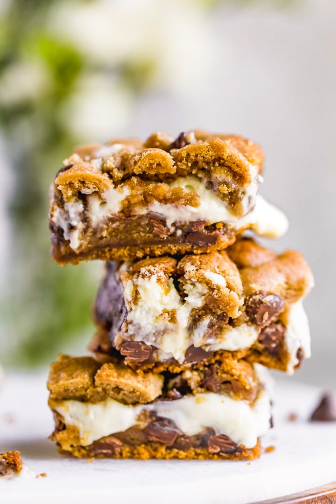 A stack of chocolate chip cookie bars filled with cheesecake/marshmallow cream