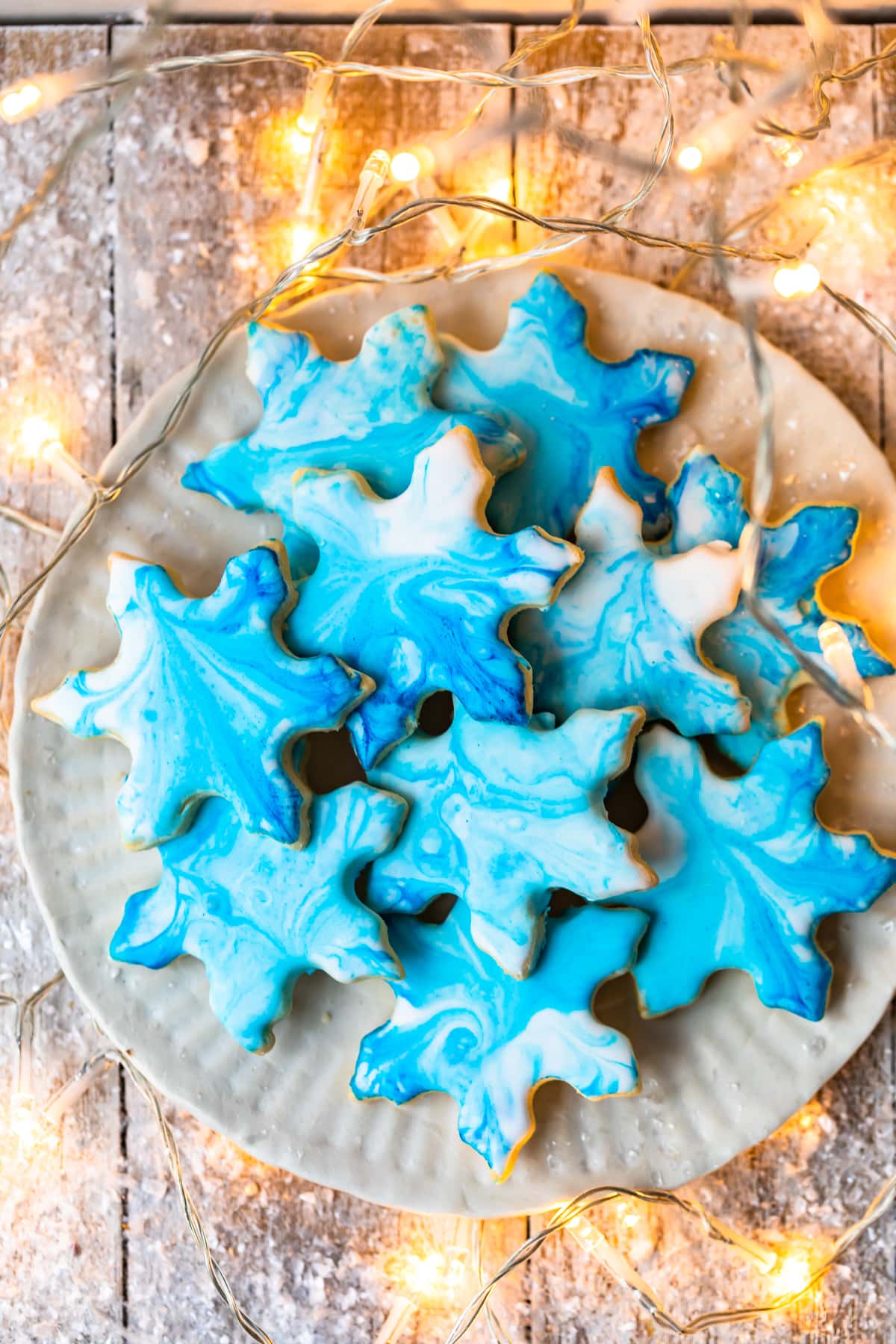 a plate of butter cookies with powdered sugar icing