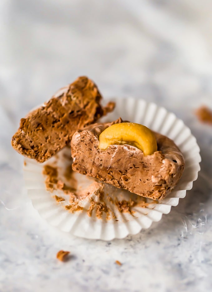 a small piece of fudge cut in half, sitting on a cupcake liner