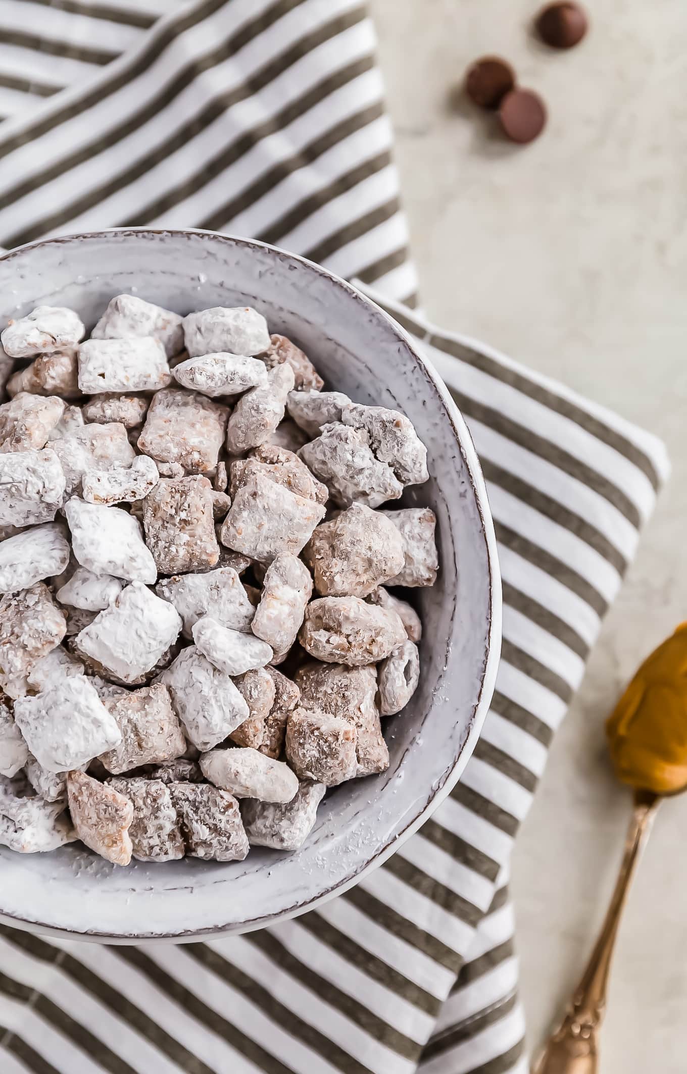 overhead view of a bowl of puppy chow on a striped dish towel