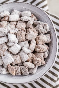 Puppy Chow is a chocolate-y treat that's sure to please! This easy puppy chow recipe includes an original version AND a mint chocolate puppy chow version. Find out how to make puppy chow for a simple yet delicious holiday treat!