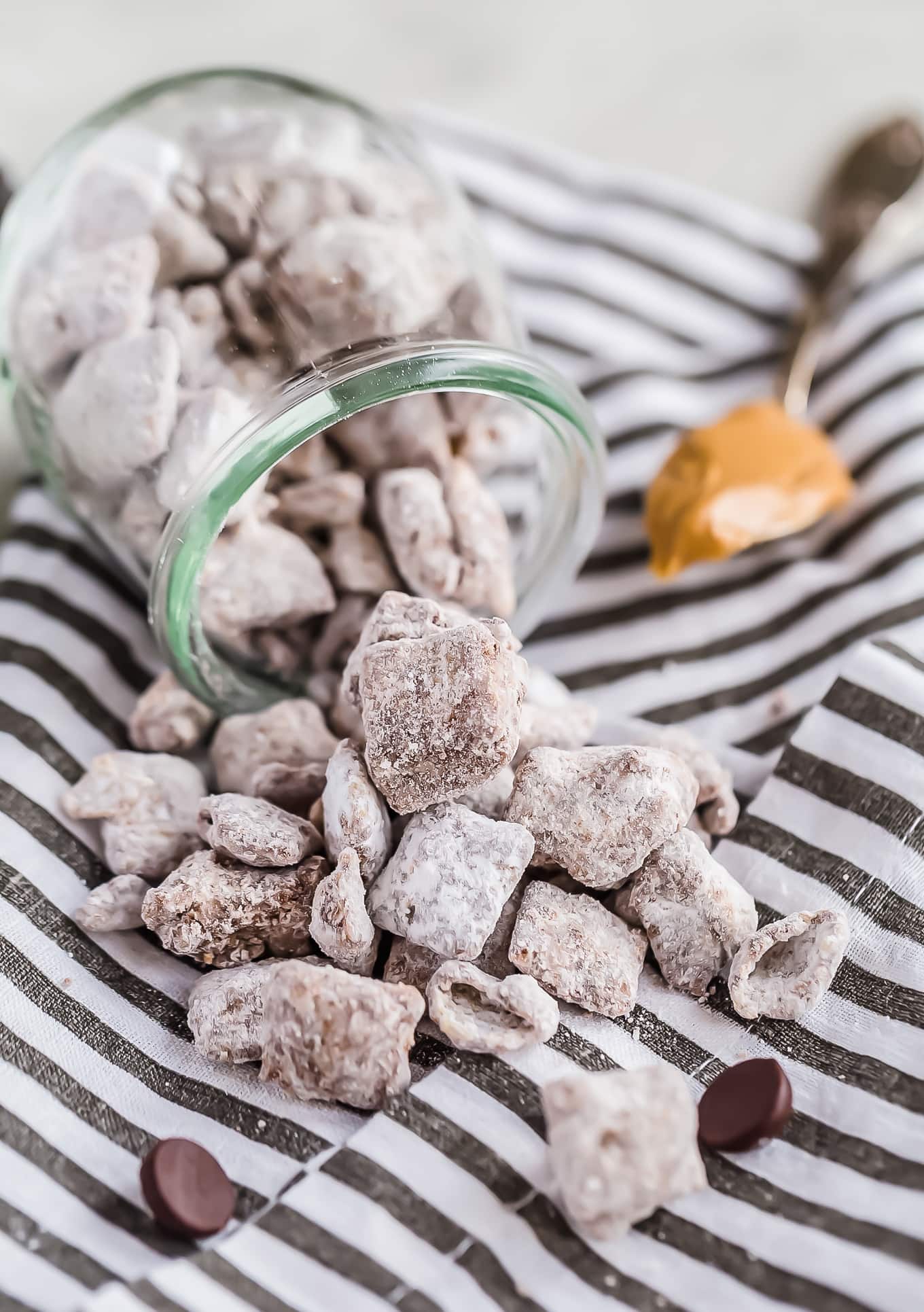 puppy chow spilling out of a jar onto a dish towel