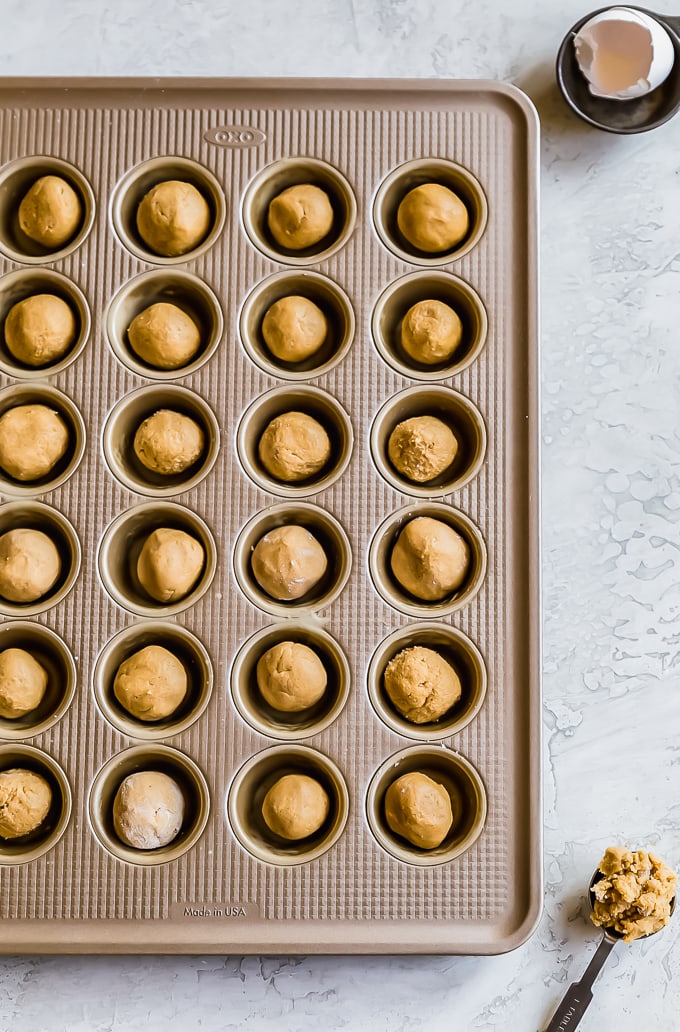 balls of cookie dough in a mini muffin tin
