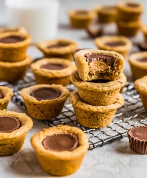 Peanut Butter Cup Cookies are the perfect little treat. Mini peanut butter cups are baked right into tart shaped cookies for a delicious bite-sized dessert. Everyone will eat these Reese's Cup Cookies right up because no one can resist chocolate peanut butter cookies!