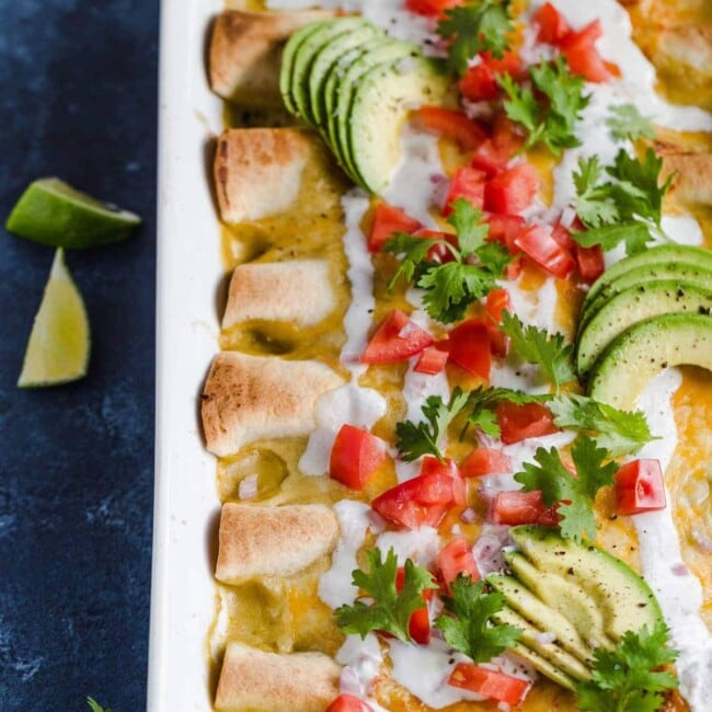 Honey Lime Chicken Enchiladas are a little bit sweet, a little bit spicy, and a whole lot of yummy! The chicken is marinated in a delicious honey lime mix, making the perfect base for these enchiladas. This easy chicken enchilada recipe is cheesy, flavorful, and fun. Try them out for your next dinner!