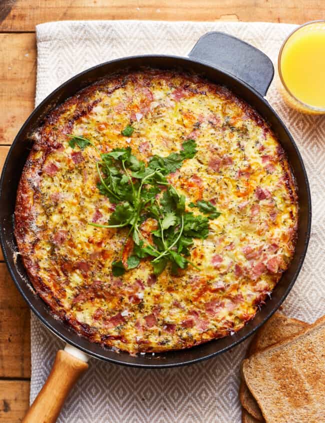 apple ham and cheese frittata in a skillet