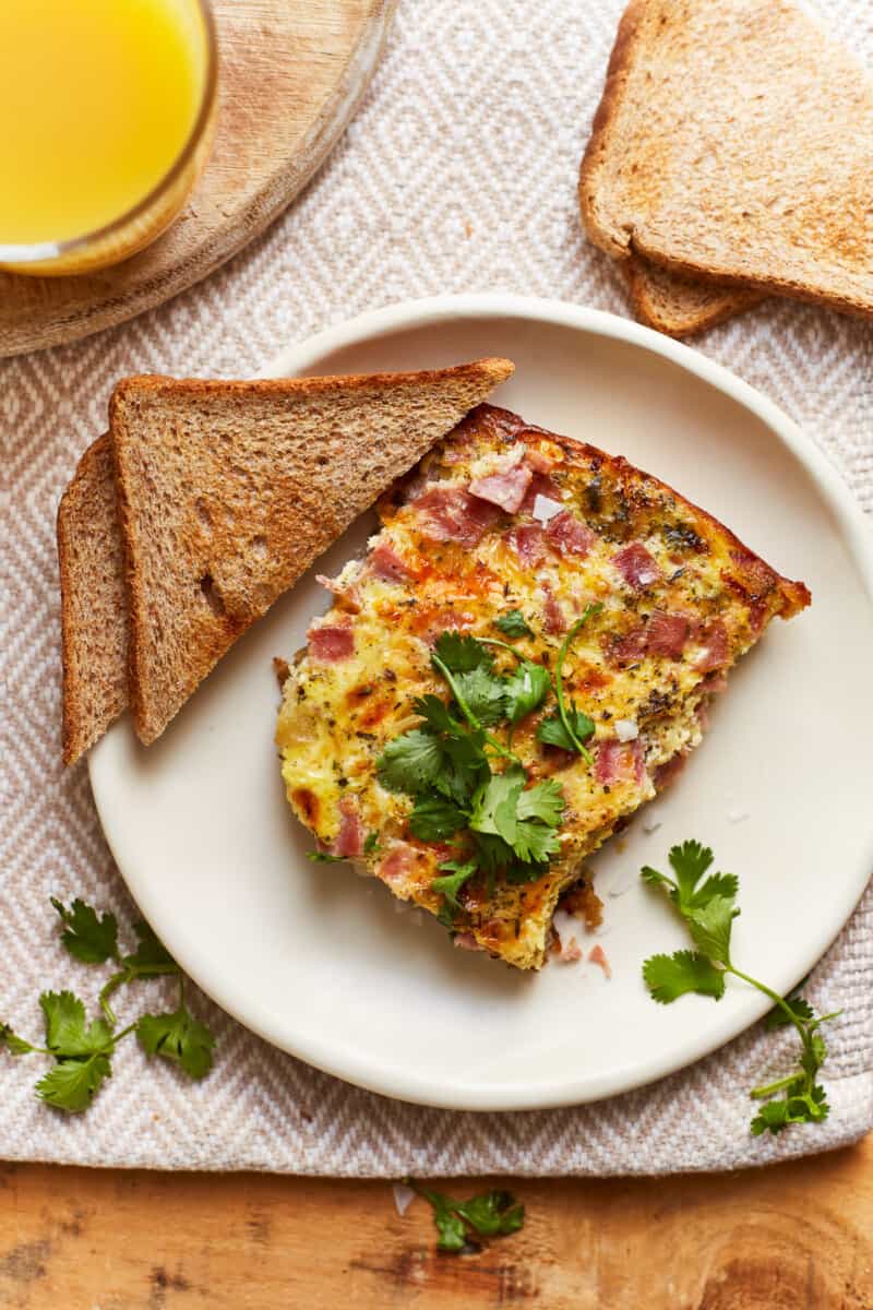 slice of apple ham and cheese frittata with toast