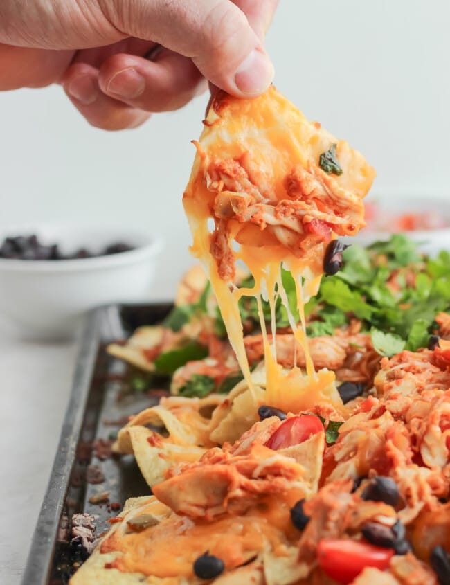 Grilled Chicken Nachos are a delicious and fun way to use your grill, even in the chillier months. Piled high with cheese and favorite toppings, the grilled smokey flavor will really surprise you! Choose from 2 flavors: BBQ Chicken Nachos or Mexican Nachos.