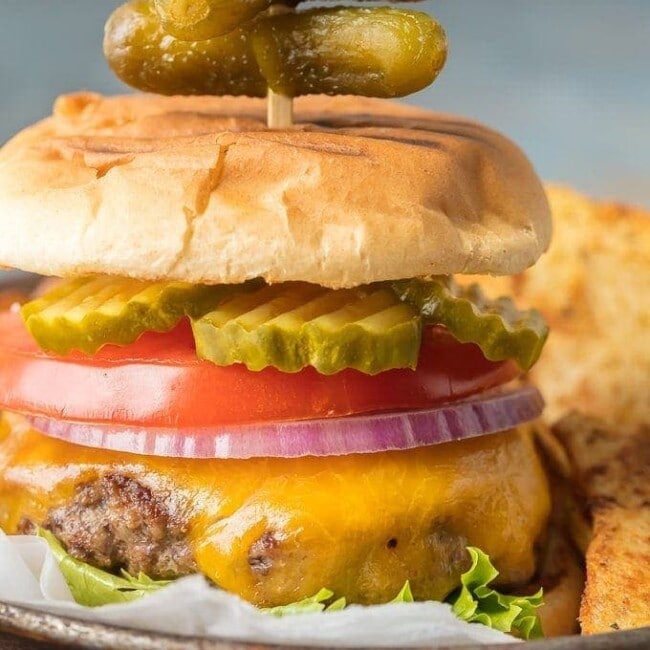 Stovetop Burgers are easier than you  might think! Once we learned How to Cook Burgers on the Stove it's our go-to easy dinner for anytime of year. Cooking Burgers on the Stove is a great way to make sure you cook a JUICY and PERFECT Stovetop Burger each and every time. Hamburgers on the Stove is the only  way to cook cheeseburgers!