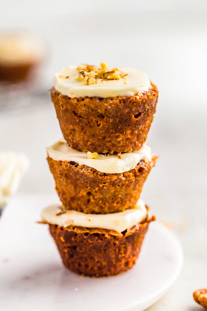 A stack of mini muffins with cream cheese frosting