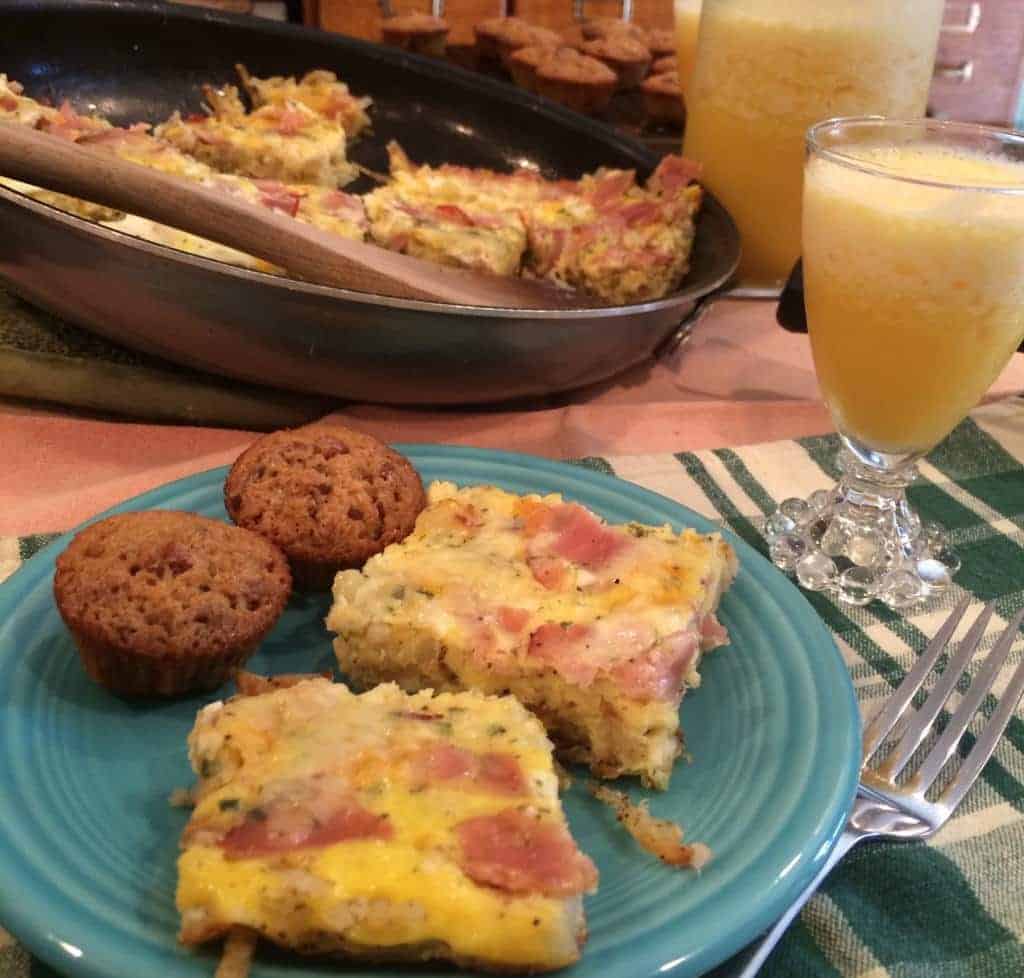 Apple and Gruyere Frittata on plate with muffins and orange juice