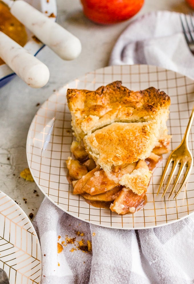 A slice of homemade apple pie on a small plate