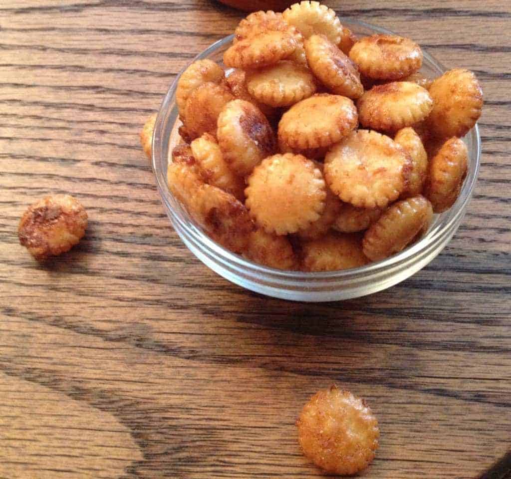 A bowl of Sriracha Maple Oyster Crackers on a table.