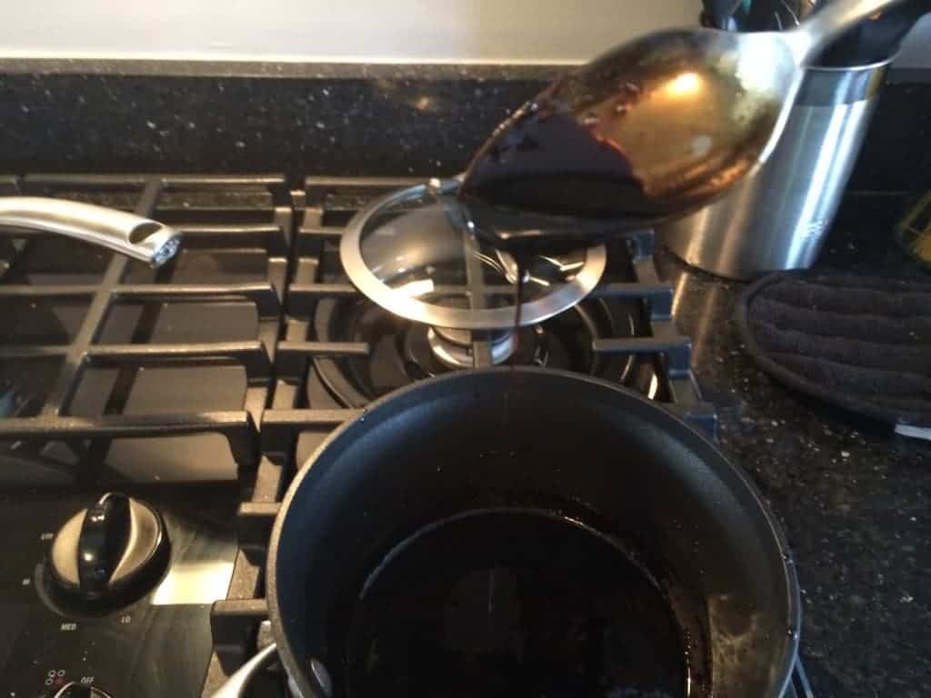 View of Balsamic Reduction being drizzled from a spoon.