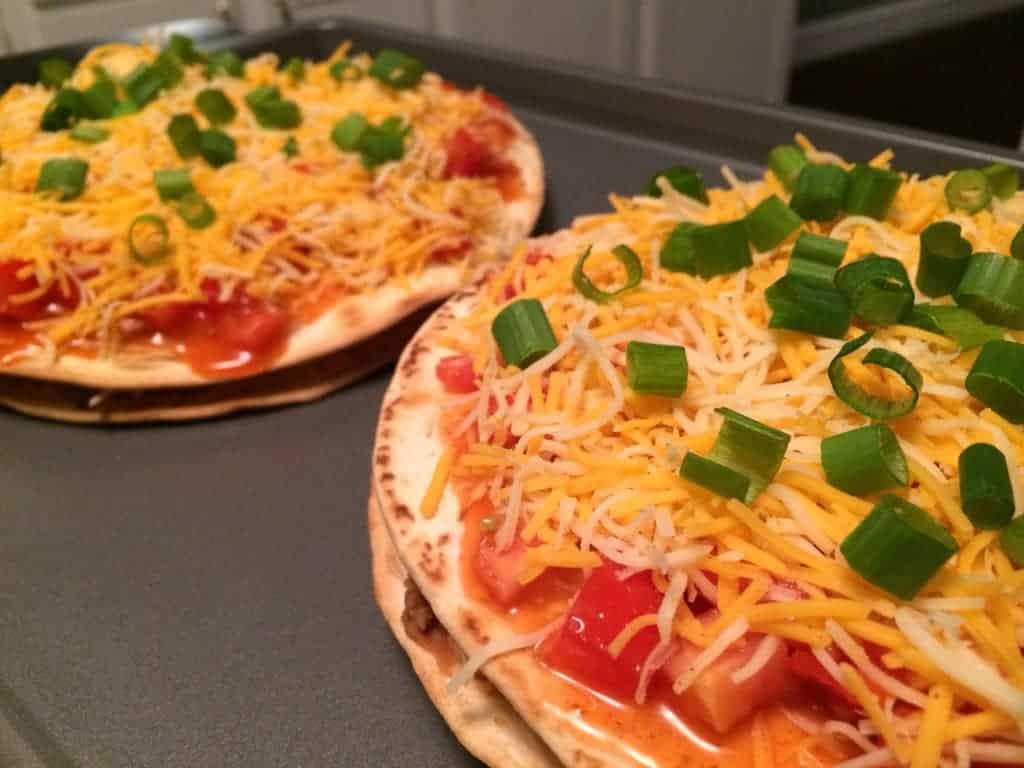 Chicken Mexican Pizzas on baking tray, ready to go in the oven.