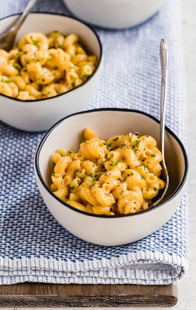 Two bowls of macaroni and cheese with forks