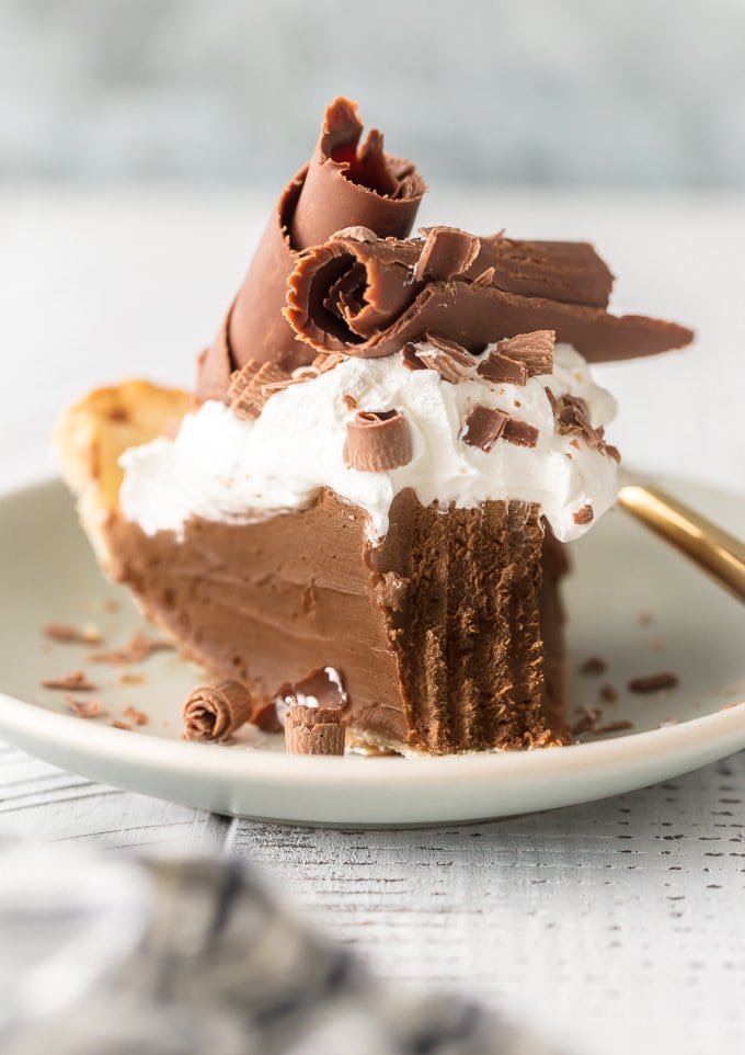 piece of chocolate silk pie with large chocolate shavings and whipped cream