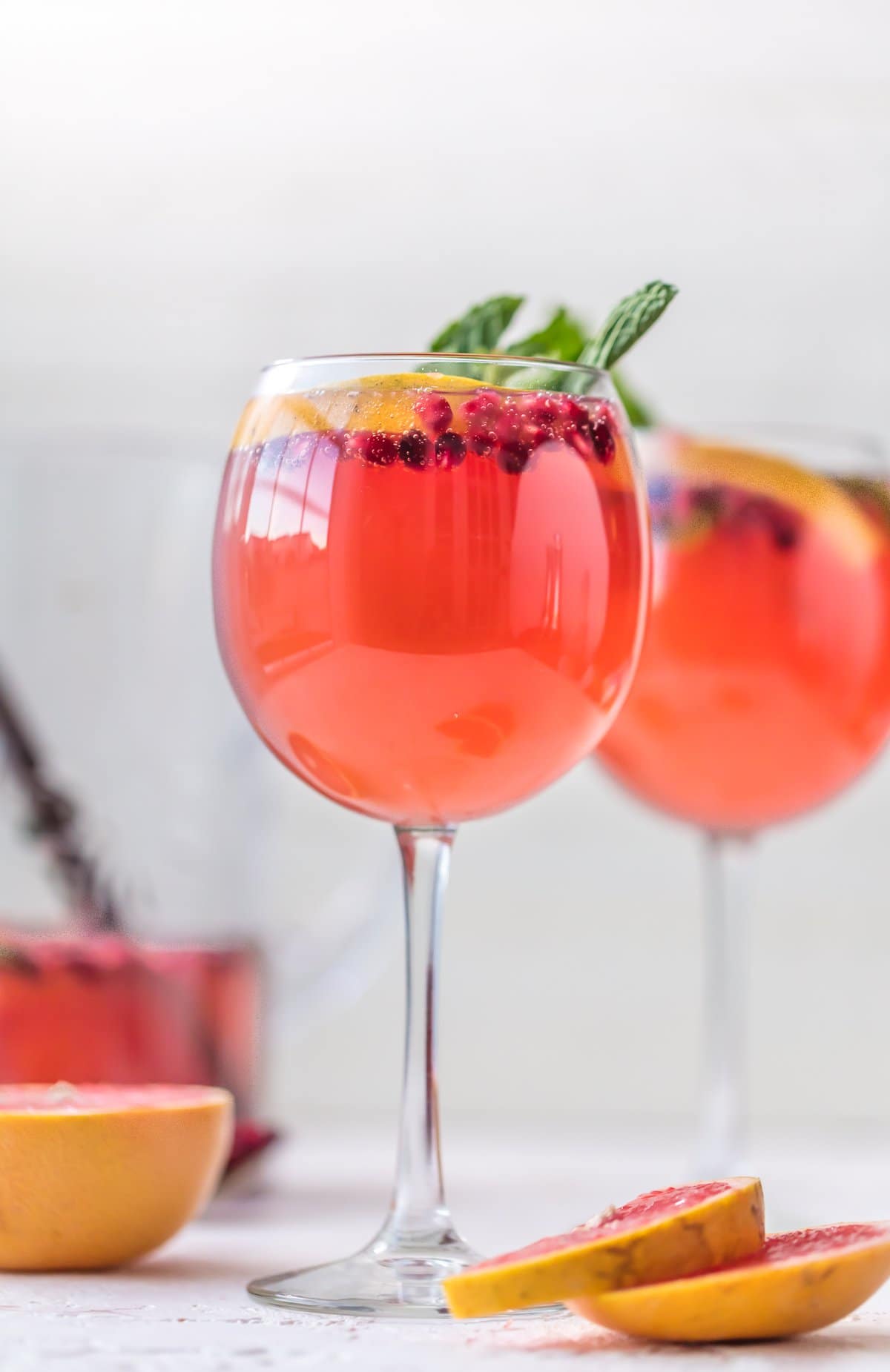Champagne Sangria in wine glasses, made with pink moscato champagne