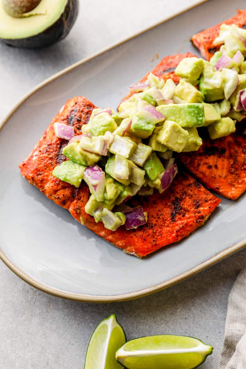 platter of grilled salmon with avocado salsa