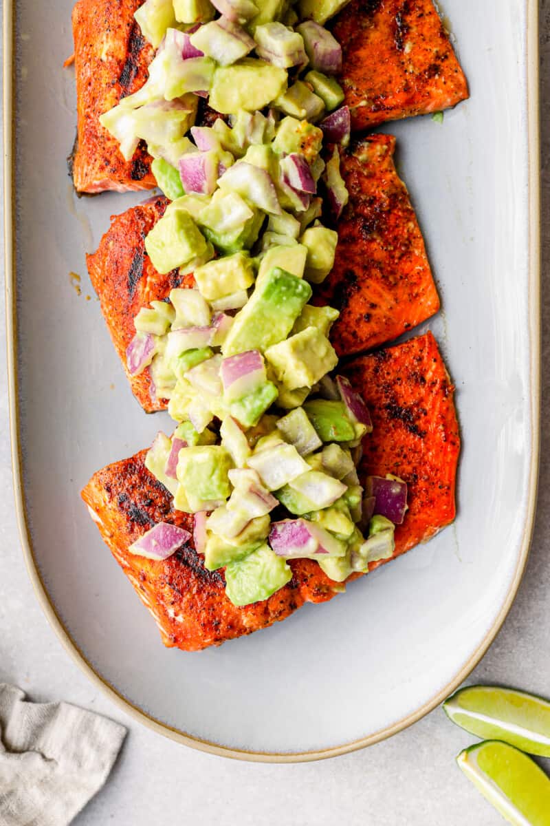 overhead platter of grilled salmon with avocado salsa