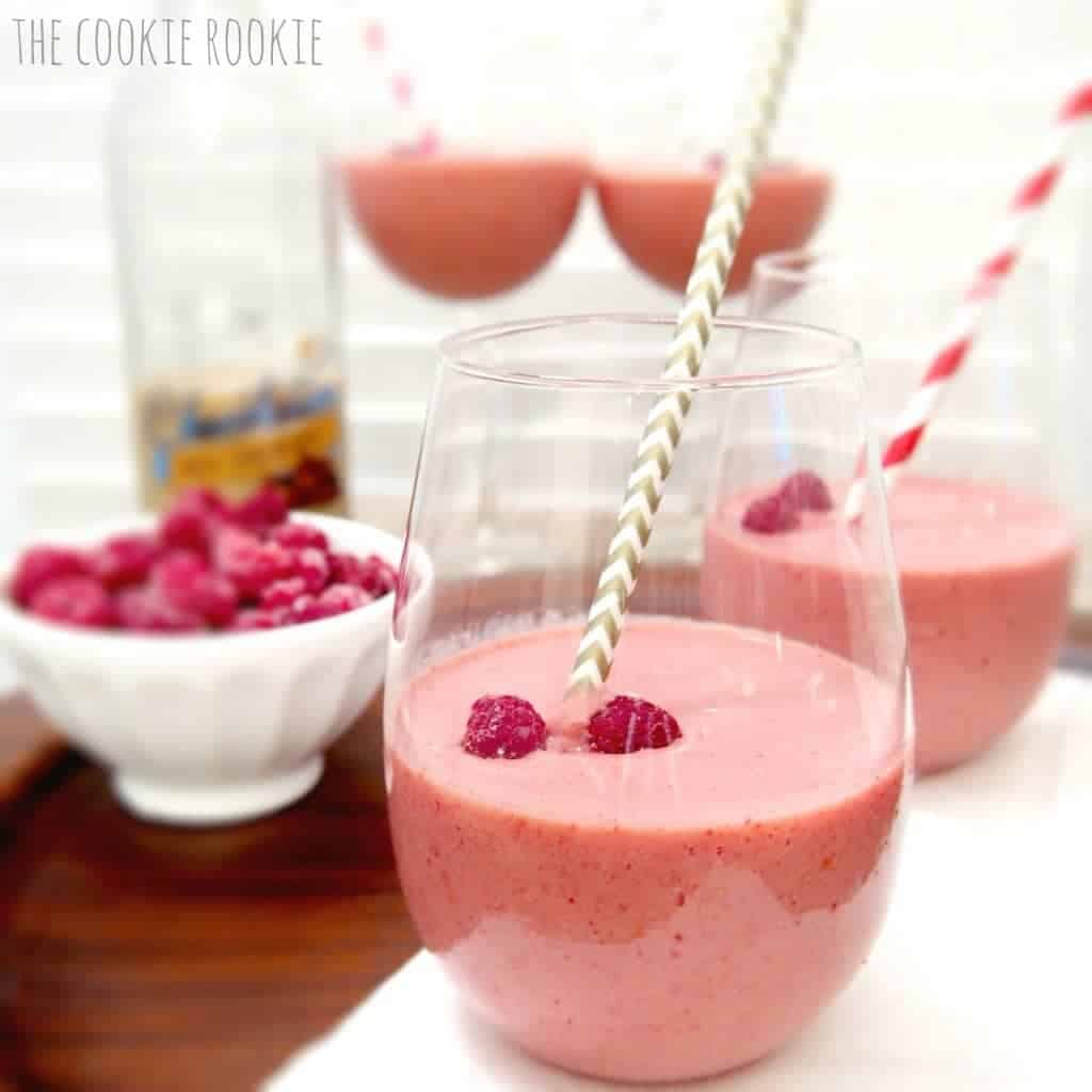 Raspberry-Chocolate Wine Smoothies garnished with raspberries and pretty straws.