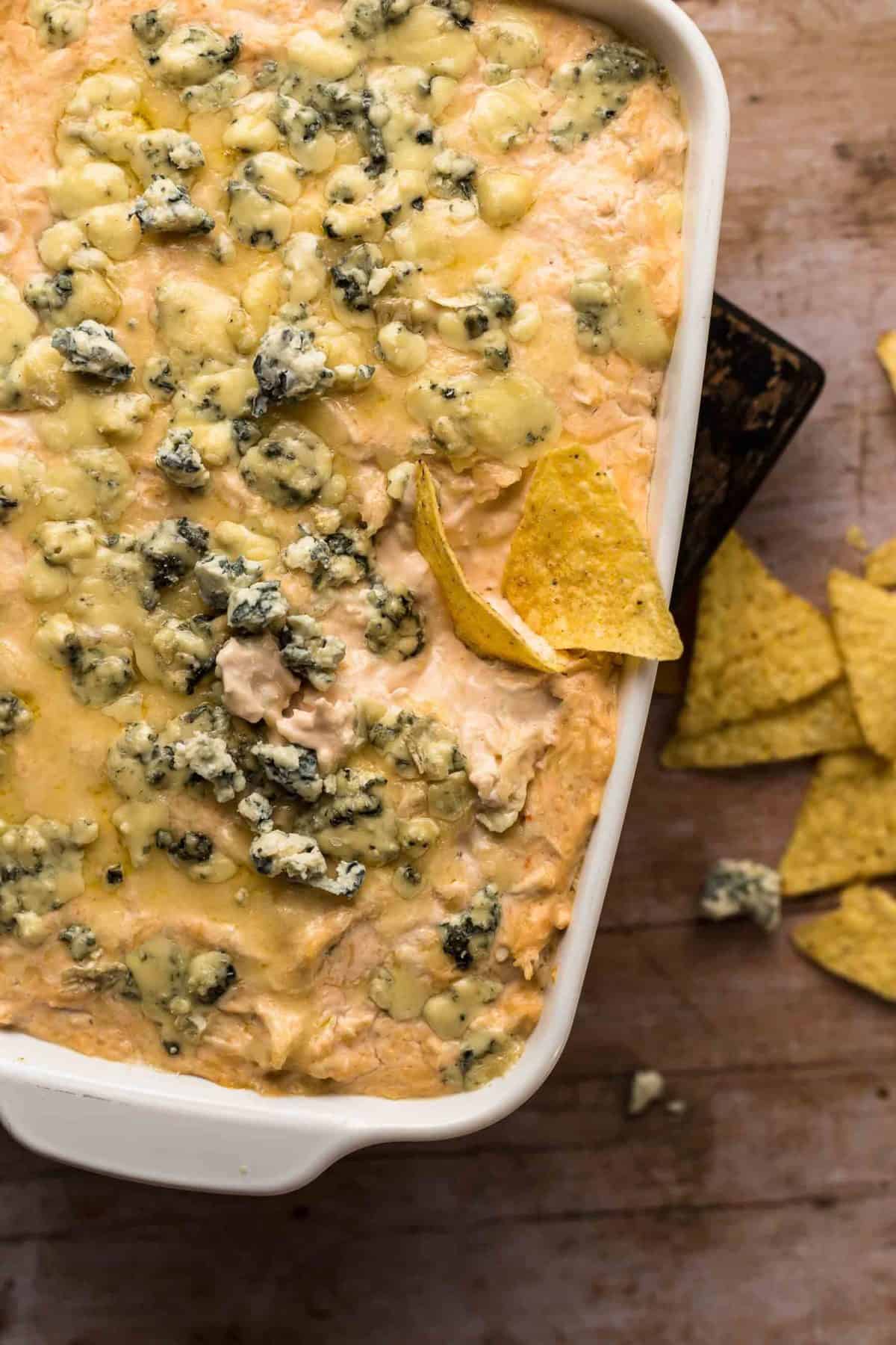 Image of Beer Cheese Buffalo Chicken Dip, with some chips for dipping.