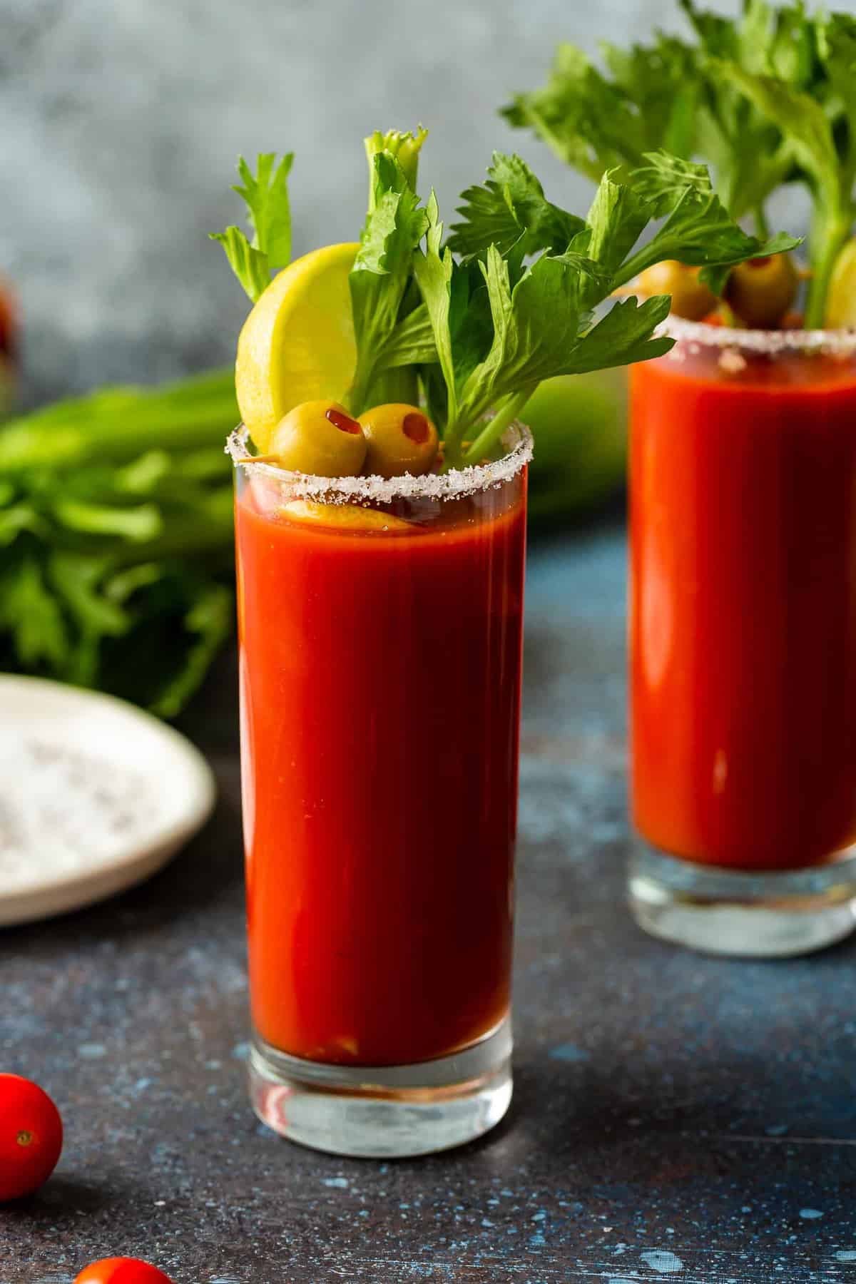 A Bloody Mary is a classic cocktail most of us have heard of, but aren't quite sure how to make. This is the BEST Bloody Mary recipe, and it happens to be really easy. Enjoy this drink with brunch (or use it to cure that hangover). This spicy cocktail is so delicious either way! Two glasses of Bloody Mary with celery sticks.