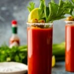 bloody mary in glass with salted rim and garnishes