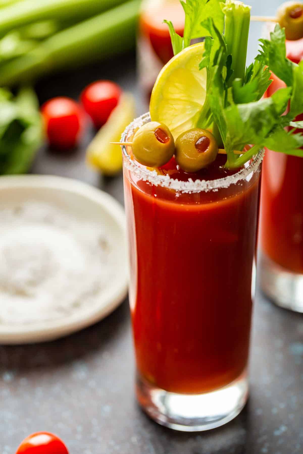 A Bloody Mary is a classic cocktail most of us have heard of, but aren't quite sure how to make. This is the BEST Bloody Mary recipe, and it happens to be really easy. Enjoy this drink with brunch (or use it to cure that hangover). This spicy cocktail is so delicious either way! Bloody Mary garnished with olives and celery