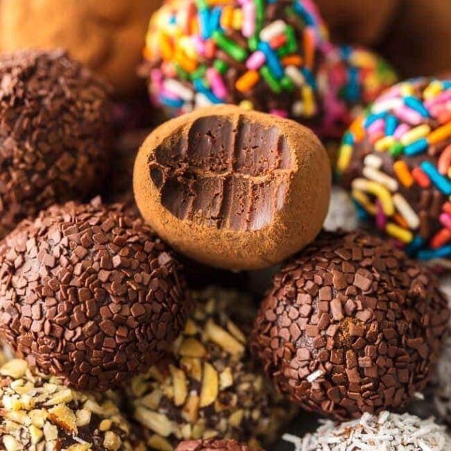 Chocolate Truffles are a must make recipe for any chocolate lover. This Easy Chocolate Truffle Recipe is made with only 5 ingredients and has a unique and amazing flavor. If you've wondered how to make chocolate truffles, this recipe is for you. Softer than fudge, bite-sized, and utterly perfect; this is a chocolate dessert recipe you simply can't miss.