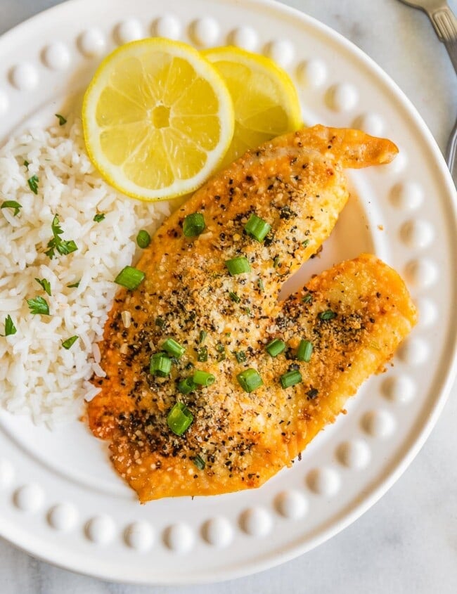 Parmesan Crusted Lemon Pepper Tilapia is the BEST Tilapia Recipe we have ever tasted. This Parmesan Crusted Tilapia is as healthy as it is delicious, and it's SUPER EASY as well! This Lemon Pepper Tilapia Recipe is so flavorful and made in under 20 minutes. Best Easy Seafood Recipe.