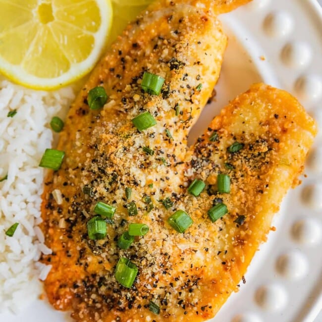 Parmesan Crusted Lemon Pepper Tilapia is the BEST Tilapia Recipe we have ever tasted. This Parmesan Crusted Tilapia is as healthy as it is delicious, and it's SUPER EASY as well! This Lemon Pepper Tilapia Recipe is so flavorful and made in under 20 minutes. Best Easy Seafood Recipe.