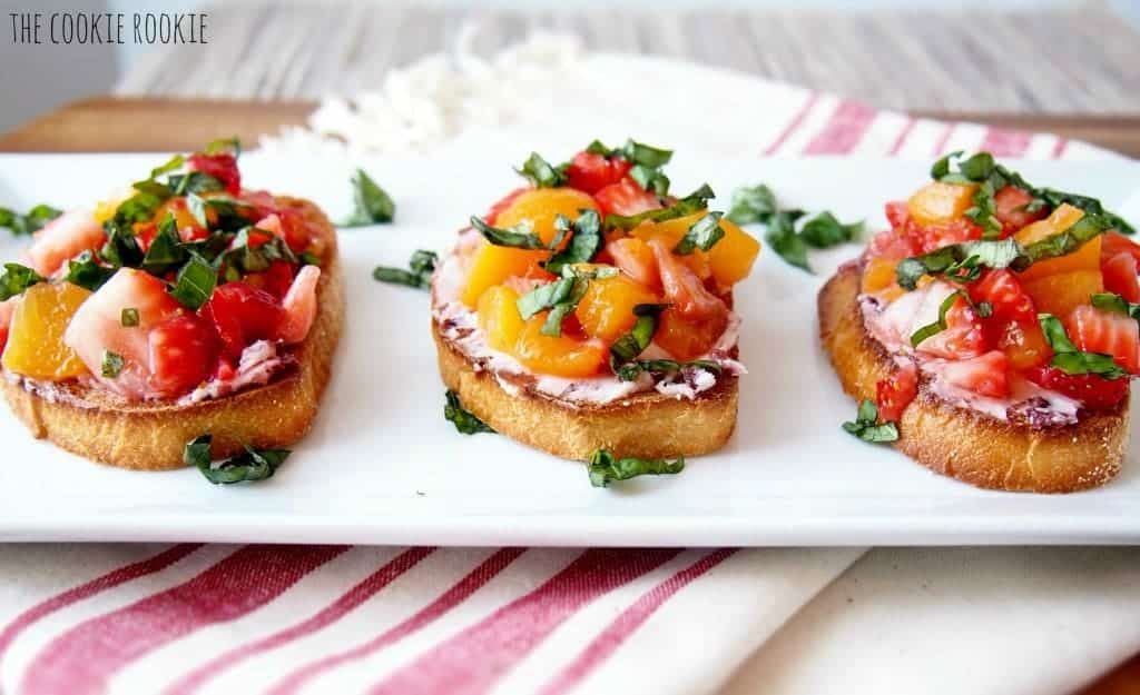 Three pieces of Peach and Strawberry Bruschetta on a tray.