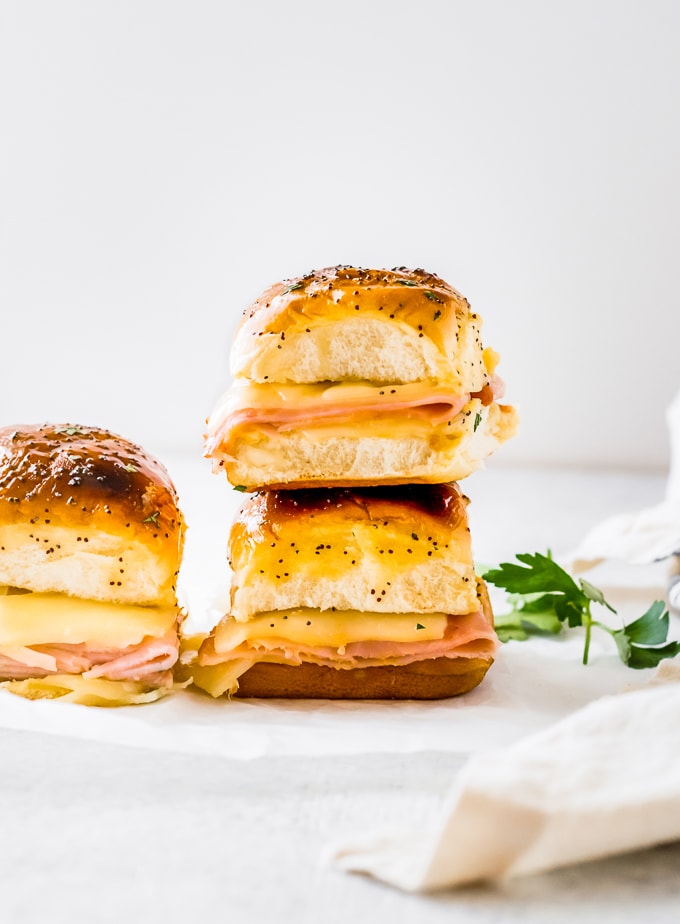 Ham and Cheese Sliders are such a simple recipe, but they're perfect for a quick lunch or snack. I am constantly on the hunt for EASY and delicious meals, and I found a new favorite! These BAKED Ham and Swiss Sliders were done in under 20 minutes, and they are surprisingly satisfying. These Hawaiian Roll Sliders are a great family meal! ham and swiss cheese sliders stacked on each other
