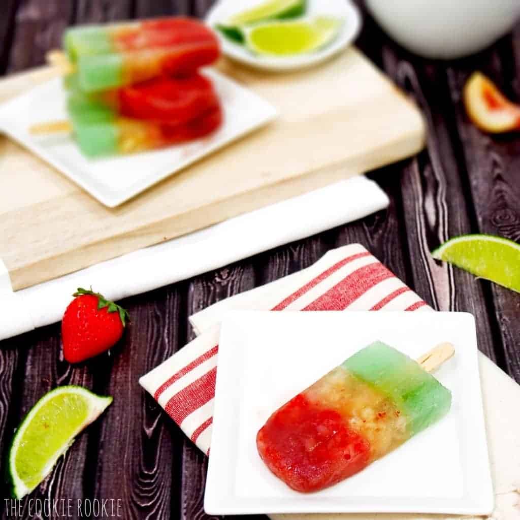 Close-up view of one ice pop on a plate, with more ice pops  in the background.