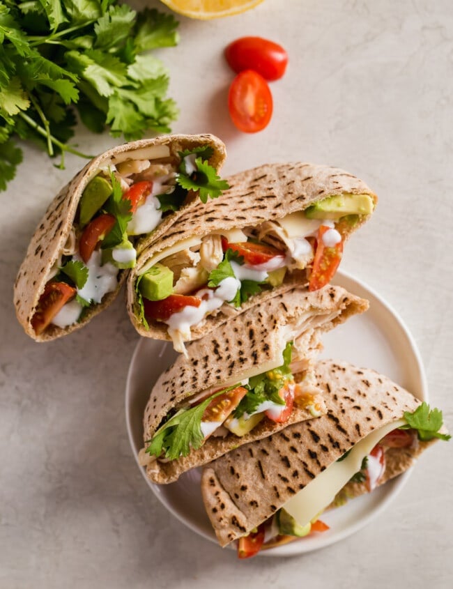 Chicken Pita Sandwiches are a healthy and delicious lunch option. This Chicken Avocado Sandwich is perfect for work days. Easy to make and so much flavor! These Chicken Avocado Pita Pockets prove that healthy lunches don't have to taste boring.