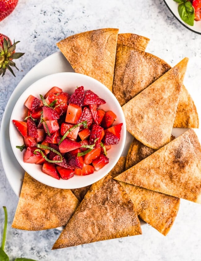 Strawberry Salsa with Cinnamon Tortilla Chips is a fresh & simple summer appetizer. This easy fruit salsa recipe pairs perfectly with homemade cinnamon sugar tortilla chips!