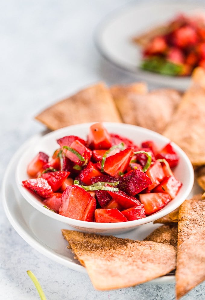 A bowl of strawberry salsa with basil